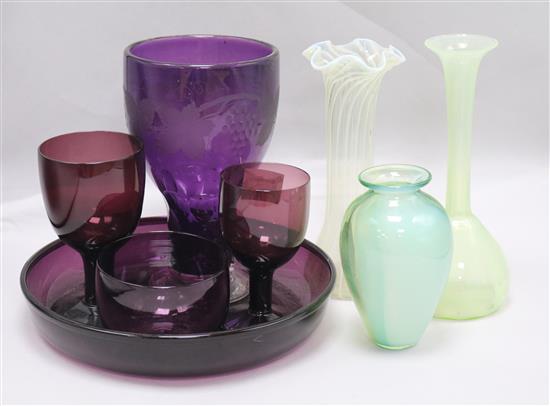 A group of amethyst glass and three vaseline glass vases